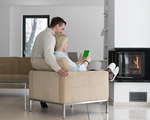 Image showing Couple using digital tablet on cold winter day