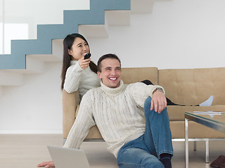 Image showing multiethnic couple on the sofa watching television