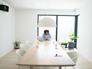 Image showing man using a mobile phone  at home