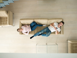 Image showing couple on sofa using mobile phones top view