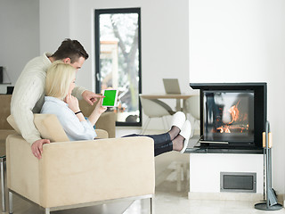 Image showing Couple using digital tablet on cold winter day