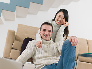 Image showing happy multiethnic couple relaxing at home