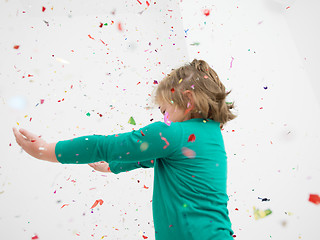 Image showing kid blowing confetti