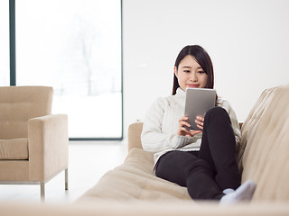 Image showing asian woman using Digital Tablet on sofa