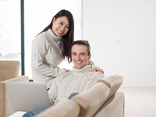 Image showing multiethnic couple using laptop computers