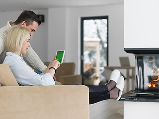 Image showing Couple using digital tablet on cold winter day