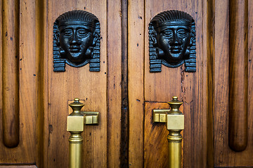 Image showing Sphinx heads entrance on wooden door