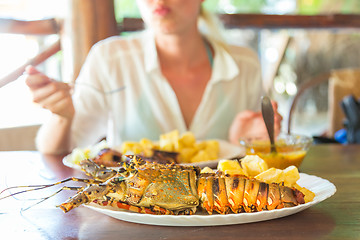 Image showing Grilled lobster served with potatoes and coconut sauce.