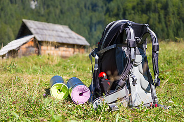 Image showing Backpack and yoga mats on mountain meadow.