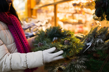 Image showing woman with fir tree wreath at christmas market