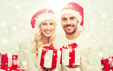 Image showing happy couple at home with christmas gift boxes