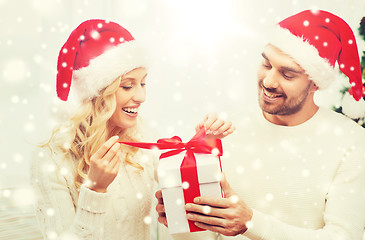 Image showing happy couple at home with christmas gift box