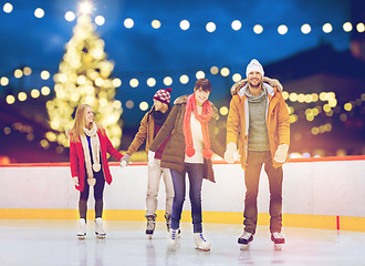 Image showing happy friends on christmas skating rink