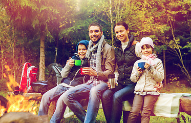 Image showing happy family drinking hot tea at camp fire