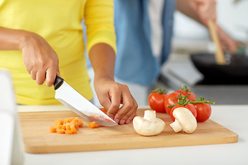 Image showing close up of african woman hands cooking food