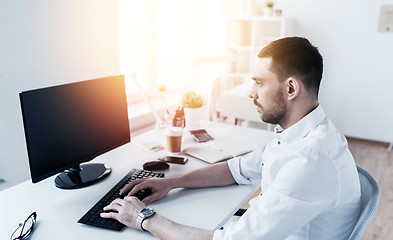 Image showing businessman typing on computer keyboard at office