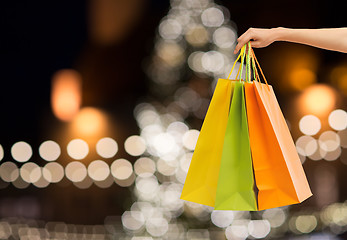 Image showing close up of hand with shopping bags at christmas