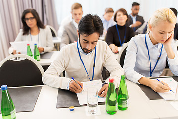 Image showing businesspeople with papers at conference