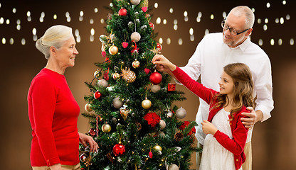 Image showing happy family decorating christmas tree