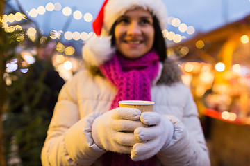 Image showing woman with cup of hot drink at christmas market