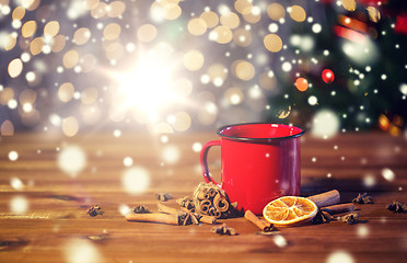 Image showing tea cup with winter spices on wooden table