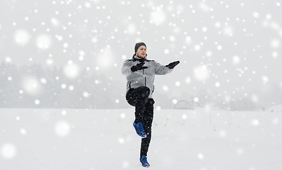 Image showing man exercising and warmig up in winter outdoors