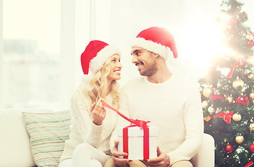 Image showing happy couple at home with christmas gift box