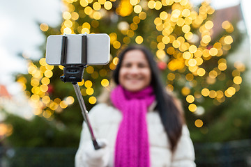 Image showing woman taking selfie with smartphone at christmas 