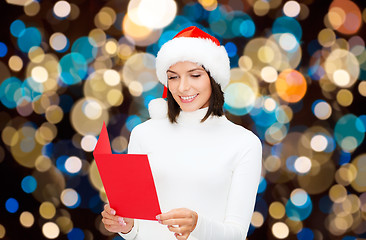 Image showing happy woman reading christmas greeting card