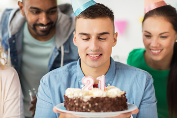 Image showing man with birthday cake and team at office party