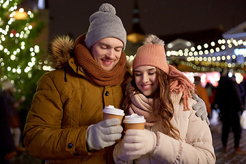 Image showing happy young couple with coffee at christmas market