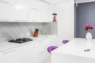 Image showing modern kitchen with dining table and purple chairs