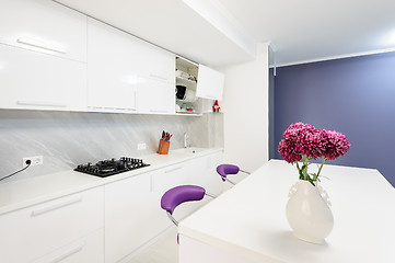 Image showing modern kitchen with dining table and purple chairs