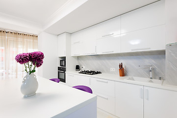 Image showing modern kitchen with dining table and purple chairs