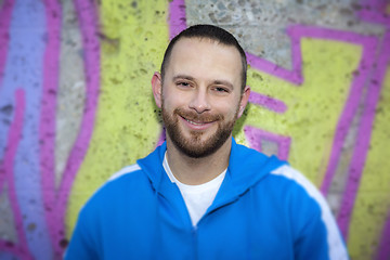 Image showing young man at a graffiti wall