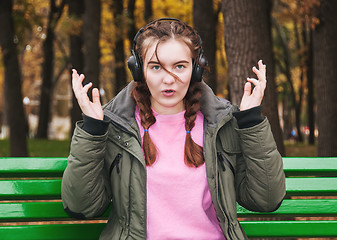 Image showing Surprised young girl with headphones