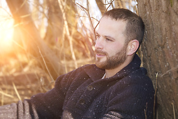 Image showing a thoughtful bearded man in the forest sunset