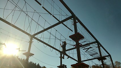 Image showing Unidentifiable boy climbing in high rope park