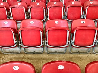 Image showing Bright red plastic seats in a stadium