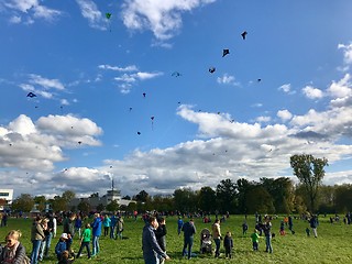 Image showing Hundreds of kites are soaring in the sky during the kite festival on the German Reunification Day