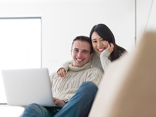 Image showing multiethnic couple using laptop computers