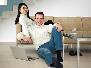 Image showing happy multiethnic couple relaxing at home