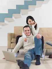 Image showing happy multiethnic couple relaxing at home