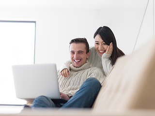 Image showing multiethnic couple using laptop computers