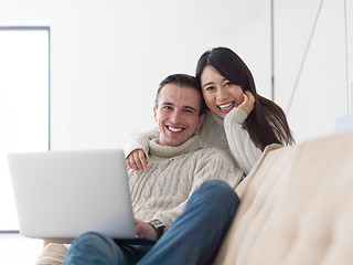 Image showing multiethnic couple using laptop computers