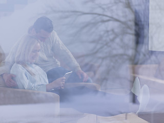 Image showing Couple using digital tablet on cold winter day