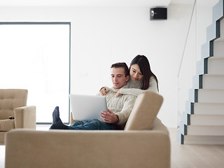 Image showing multiethnic couple using laptop computers