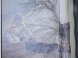 Image showing Couple using digital tablet on cold winter day