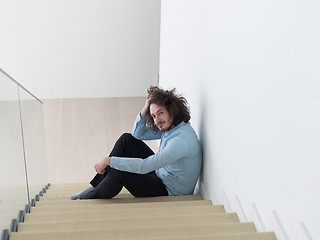 Image showing young man sitting on the stairs