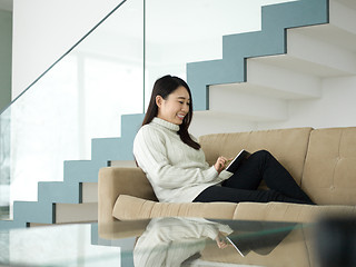 Image showing asian woman using Digital Tablet on sofa